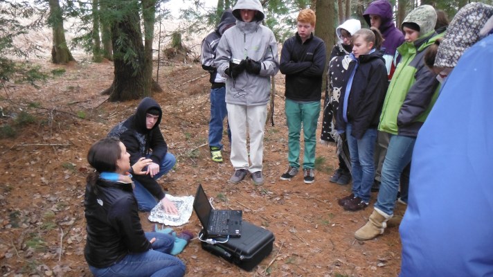 Researcher Elizabeth Webb (seated) explains microbial respiration to BFA-Botany class in the forest understory at BFA