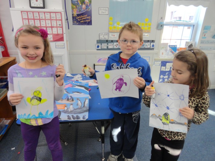 Proud artists display their penguins.