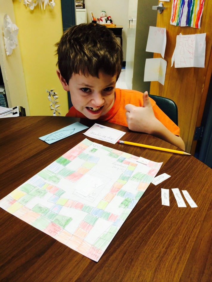 A Fletcher student plays a game he designed around the PBIS behavior system. Modeled after Monopoly, the game takes students through the steps of positive behavior. (The Principal lost to the student while playing the game!!!)
