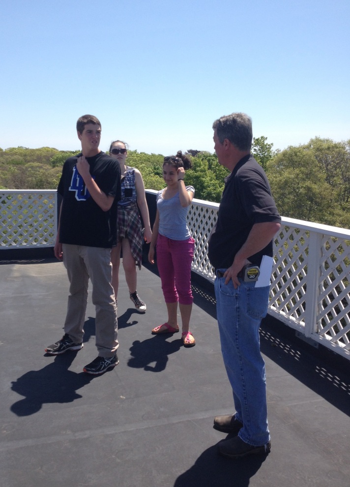 (Facilities Coordinator Fred Palmer explains how the WHRC main building is  efficient to BFA students Dave Legris, Sophie Lee and Rebekah Larose while  standing on its roof.) 