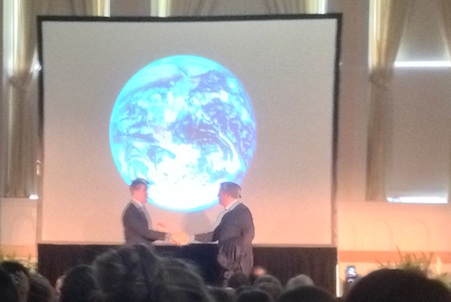Seventh Generation CEO John Replogle and Al Gore former Vice President greet each other in front of a picture of the earth from space at Ira Allen Chapel UVM campus.