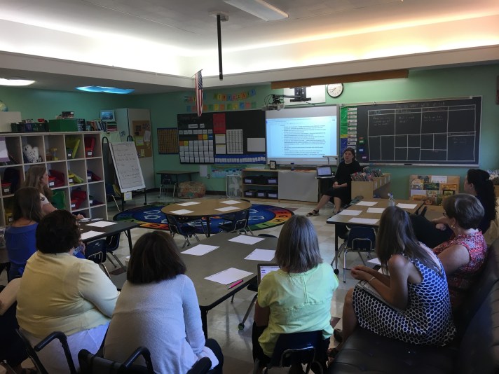 Juliet King discussing FWSU literacy progress monitoring with the K-2 team.