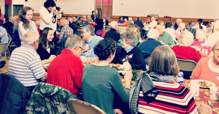 GEMS students visit with community members.