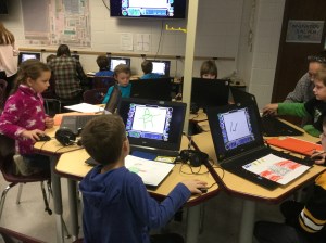 Students collaborate in the Innovation Lab to record voiceover for their writing.