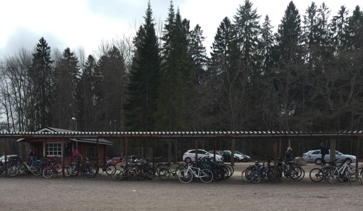 Bikes lined up outside of school even though the snow has barely melted and the temperature is a cool 40 degrees