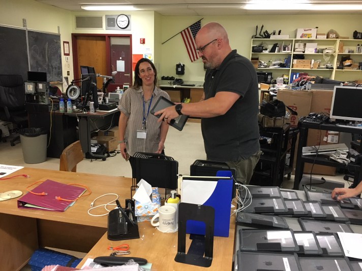 FWSU IT Technician Jason Smith assists an employee with a 1:1 Apple iPad device