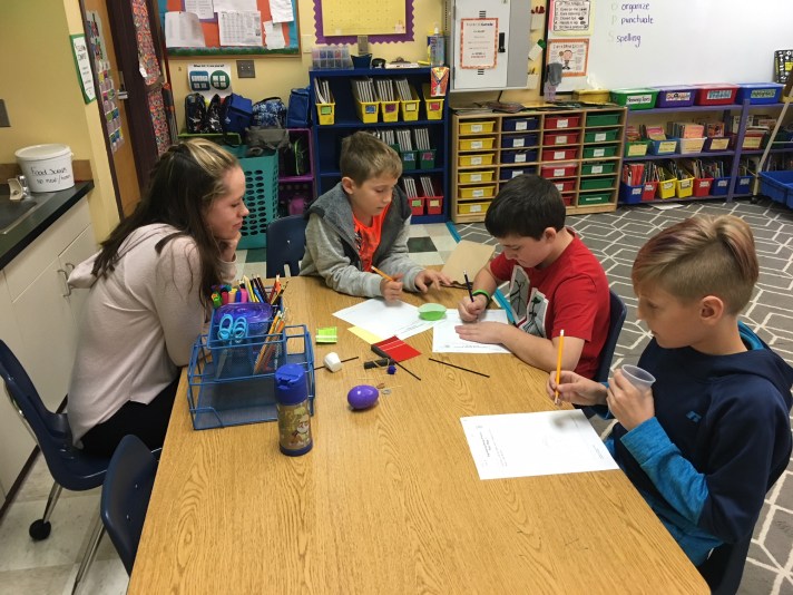 Students interact in a classroom